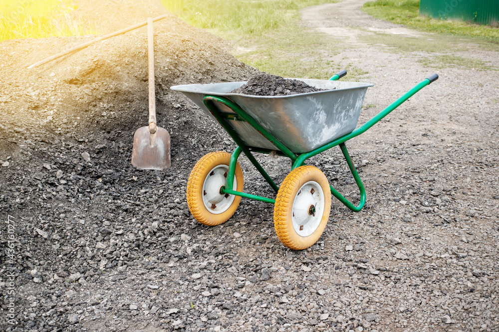 wheelbarrow with a shovel and gravel. as part of a construction project