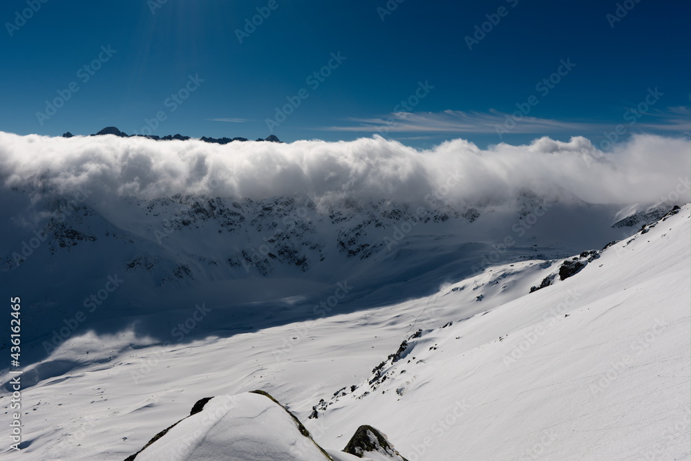 Tatra Mountains Poland. The Valley of the Five Polish Ponds. Clouds billow over the mountain valley.