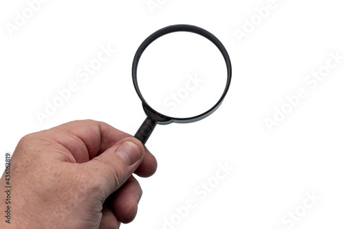 The hand holds a magnifying glass isolate against a white background.