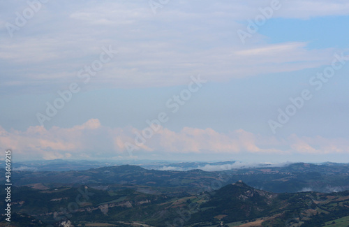 Beautiful landscape with mountainous terrain and cloudy skies. Panoramic view of Italy from San Marino © Alexander