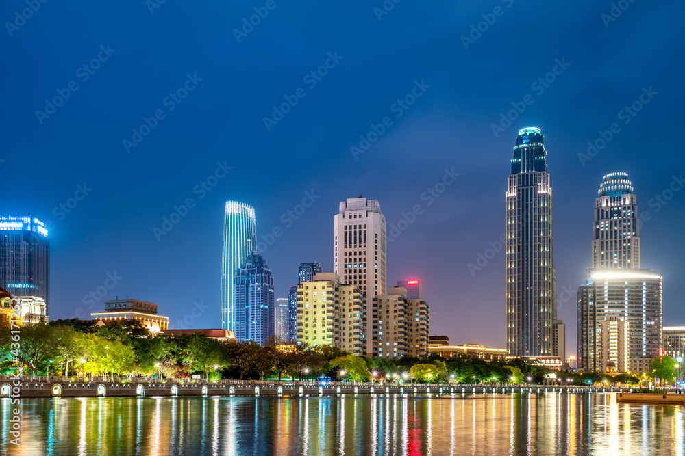 Fototapeta premium Night view of modern architecture street along Haihe River in Tianjin