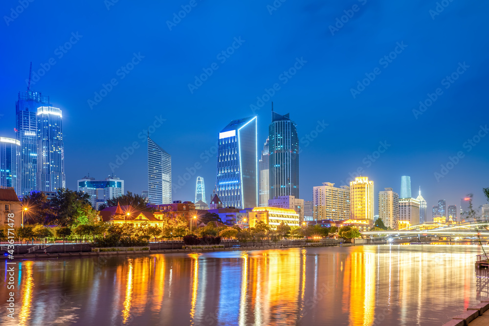 Fototapeta premium Night view of modern architecture street along Haihe River in Tianjin