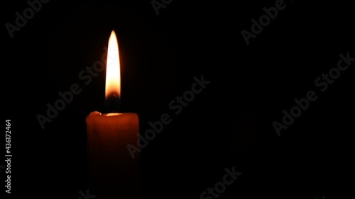 Burning Candle is an incredible stock video that displays footage of a burning candle on a black background with a copytext space. 