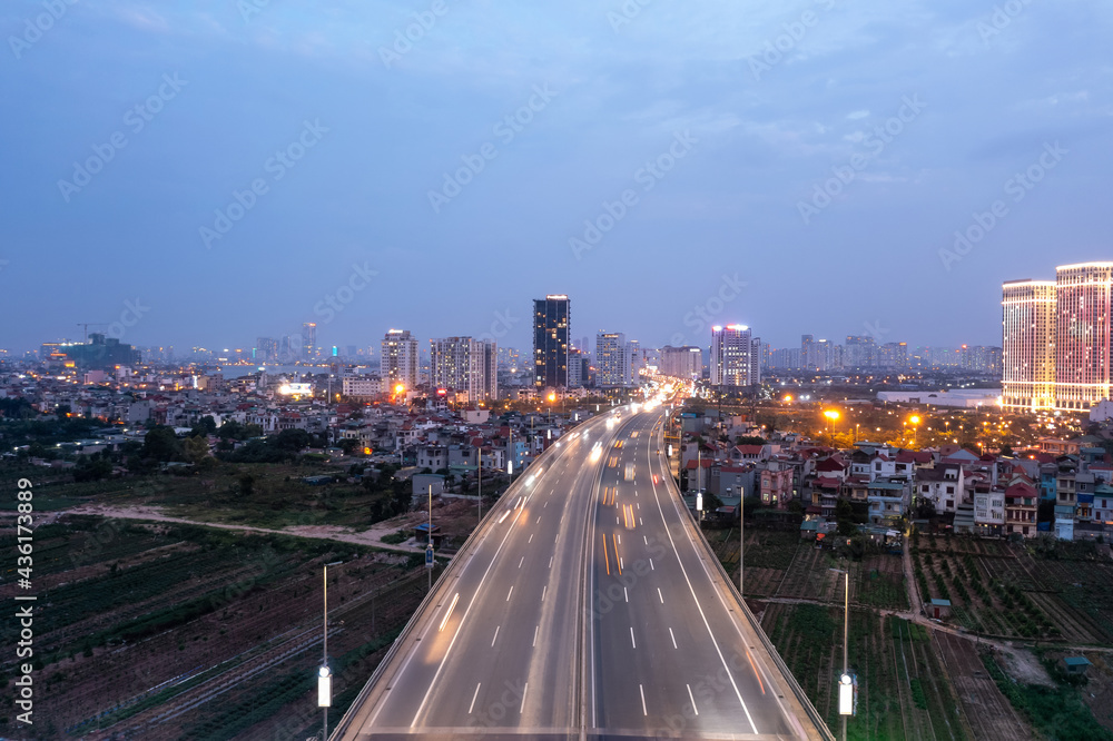 Hanoi cityscape with Vo Chi Cong street to Nhat Tan bridge, during twilight