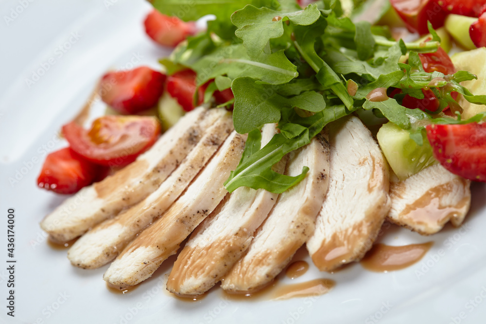 chicken fillet with salad and strawberries
