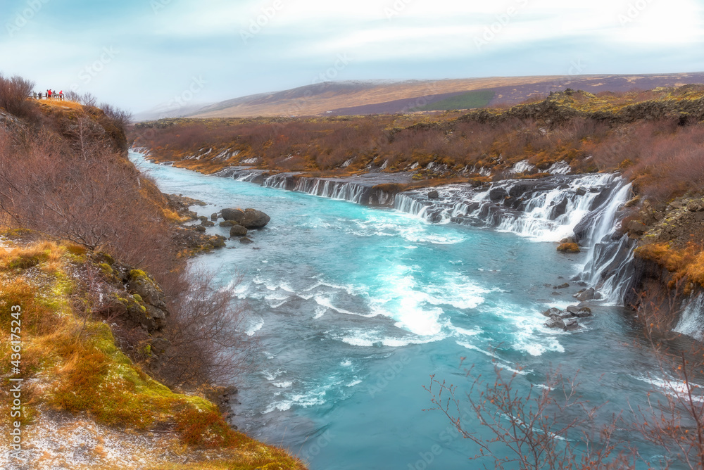Hraunfossars waterfall or called lava waterfalls, One of the popular waterfalls for tourist visit near the village of Reykholt, Borgarbyggd in west Iceland. Hraunfossars waterfall or called lava waterfalls, One of the popular waterfalls for tourist visit near the village of Reykholt, Borgarbyggd in west Iceland.