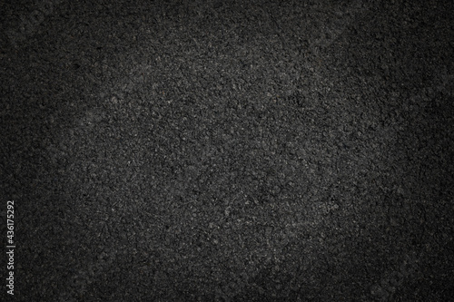 Surface grunge rough of asphalt, Grey grainy road lit in the center and shadows edges, Texture background with vignette, Top view
