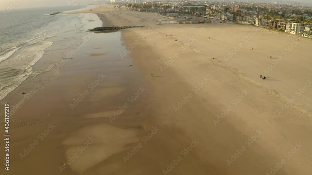 Aerial Forward Beautiful Shot Of Beach By City Against Cloudy Sky During Sunset - Los Angeles, California Aerial Forward Beautiful Shot Of Beach By City Against Cloudy Sky During Sunset - Los Angeles, California