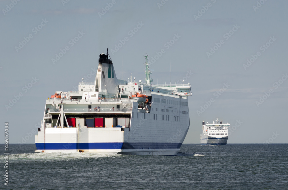 Naklejka premium MARITIME TRANSPORT - Passenger ferrys on waterway to seaport 