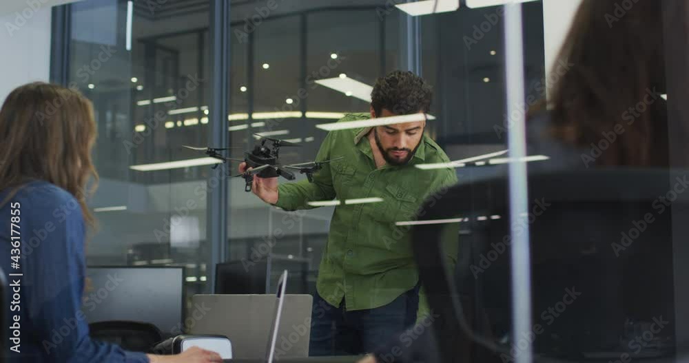 Mixed race businessman using drone during meeting Mixed race businessman using drone during meeting