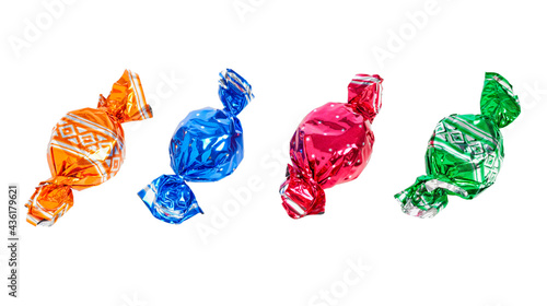 Banner with four wrapped candies isolated on white background photo