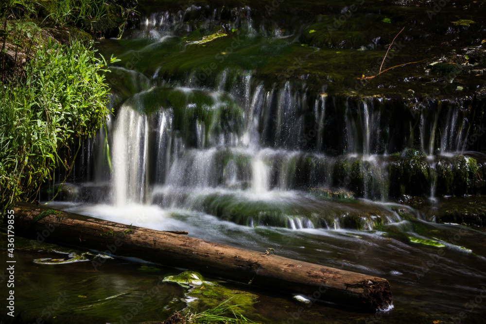 Cascading waterfall cascades in Estonia in green light at summertime Cascading waterfall cascades in Estonia in green light at summertime
