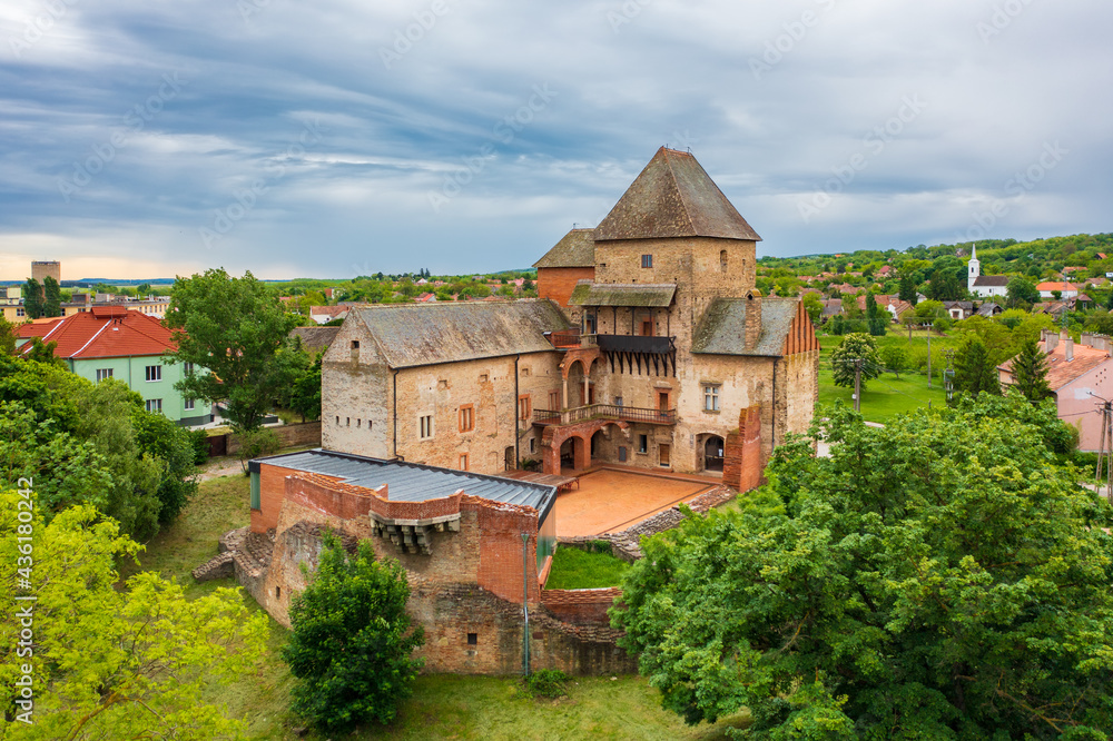 Aerial panoramic view about Castle of Simontornya with cloudy sky at the background.