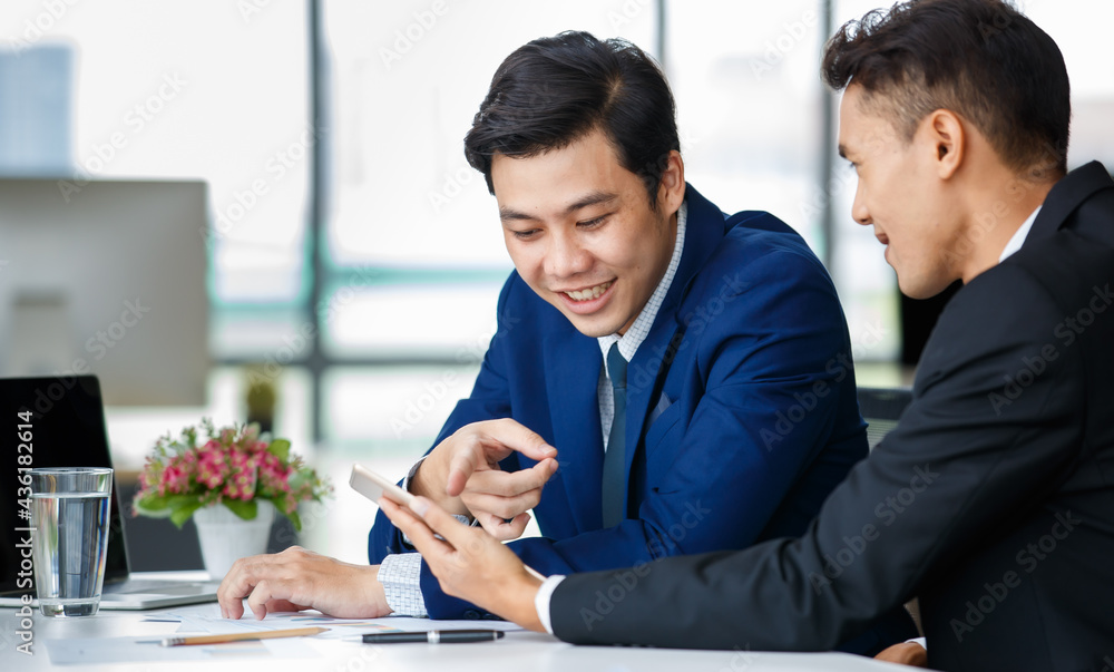 Cheerful ethnic businessmen discussing project in office Cheerful ethnic businessmen discussing project in office
