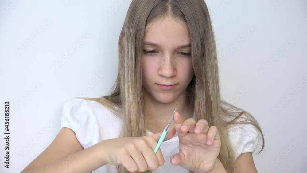 Girl Cutting Fingernails doing Manicure, Teenager Child Cuts Nails Cuticle in Sofa, Adolescent Kid Polishing Nails in Bedroom Girl Cutting Fingernails doing Manicure, Teenager Child Cuts Nails Cuticle in Sofa, Adolescent Kid Polishing Nails in Bedroom