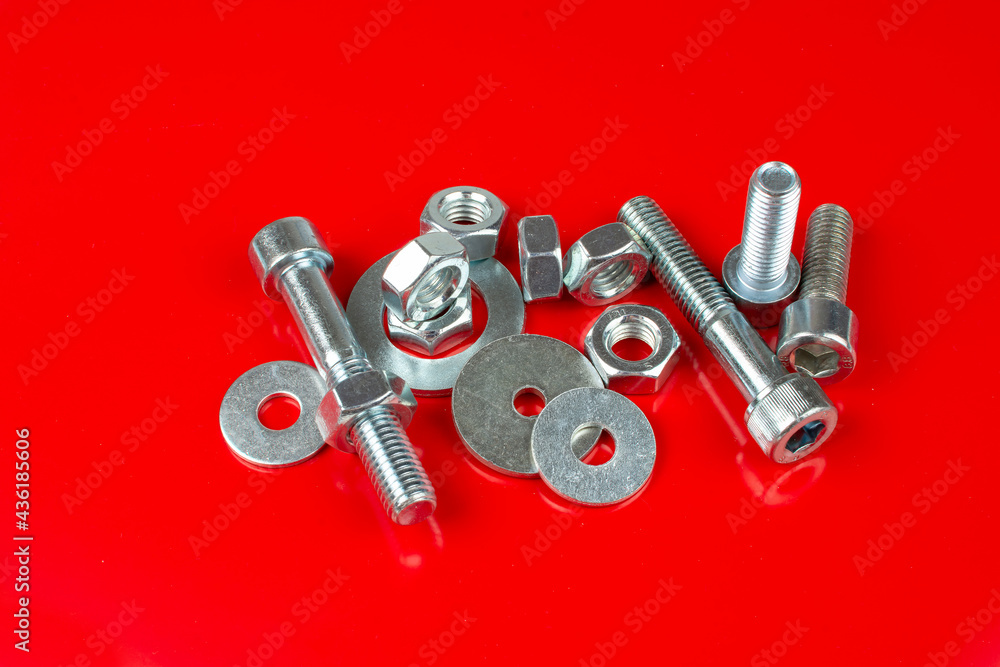 bolts and nuts for fastening structures on a red background bolts and nuts for fastening structures on a red background