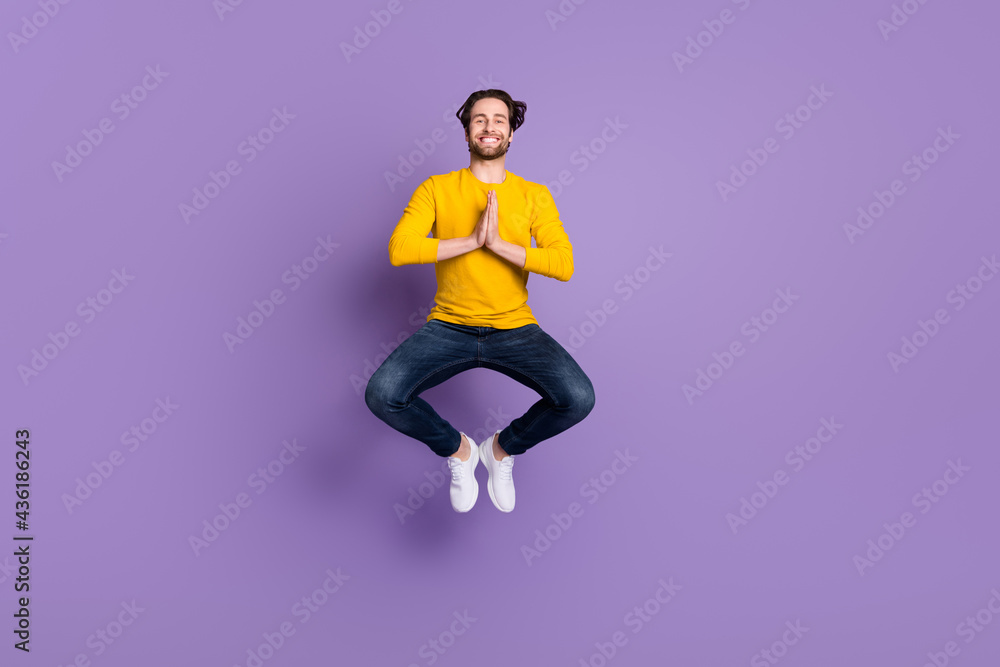 Full length body size photo smiling man in casual outfit jumping up practising yoga isolated pastel purple color background Full length body size photo smiling man in casual outfit jumping up practising yoga isolated pastel purple color background
