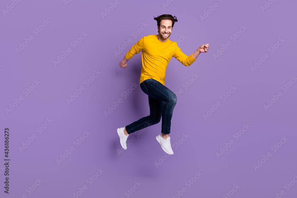 Full length body size photo smiling man jumping up running fast isolated pastel purple color background