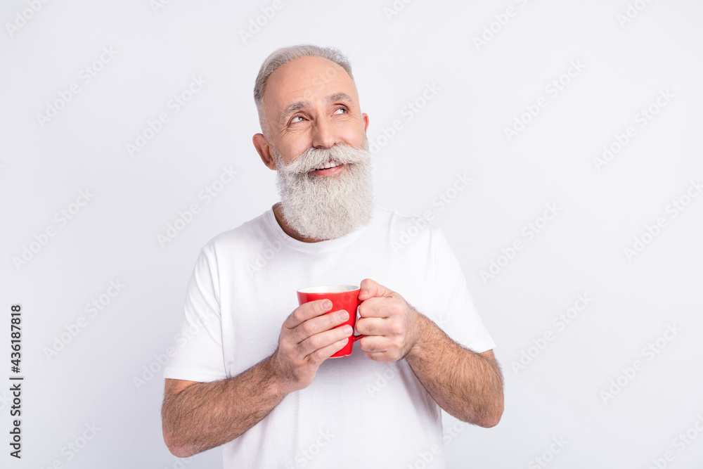 Portrait of attractive cheerful minded dreamy man drinking caffeine thinking copy space isolated over light grey color background Portrait of attractive cheerful minded dreamy man drinking caffeine thinking copy space isolated over light grey color background