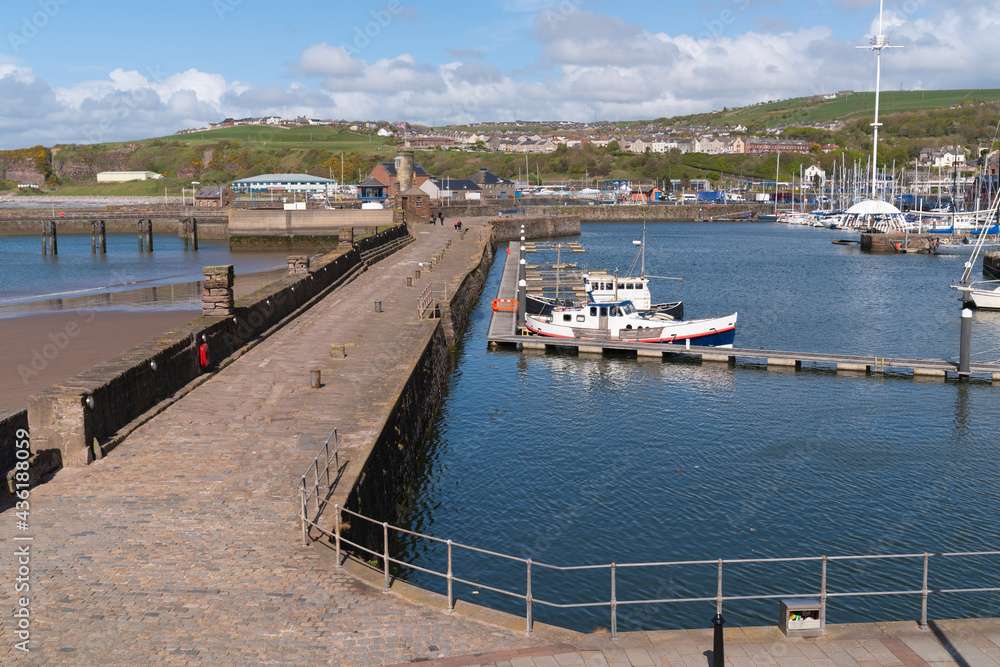 Whitehaven UK harbour wall with boats Cumbria coast near the Lake District