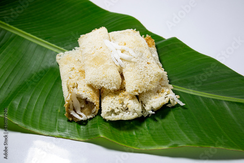 A common rice cake from Bangladesh, local name Binni chaler pathishapta pitha, goigga pitha, Puli, biroin chaler petha, binni rice pitha. Made by Forbidden Rice, coconut and sugar. on Banana leaf.