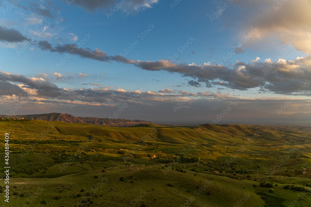 Obraz premium Beautiful summer landscape, panoramic green field and. mountains after sunset.