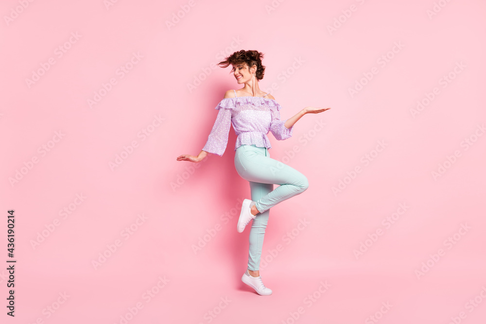 Full size photo of young happy smiling cheerful positive good mood girl dancing isolated on pink color background Full size photo of young happy smiling cheerful positive good mood girl dancing isolated on pink color background