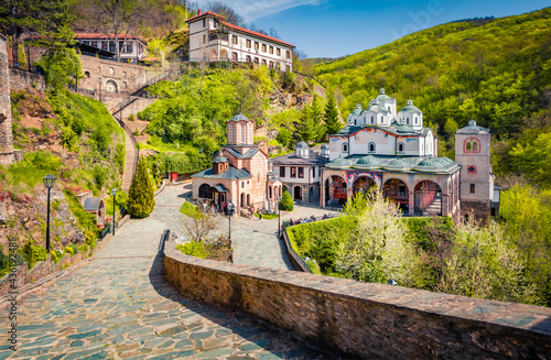 Many tourists visit Saint Joachim Osogovski Orthodox monastery & church complex with elaborate frescoes. Bright spring scene of North Macedonia, Europe. Traveling concept background. photo