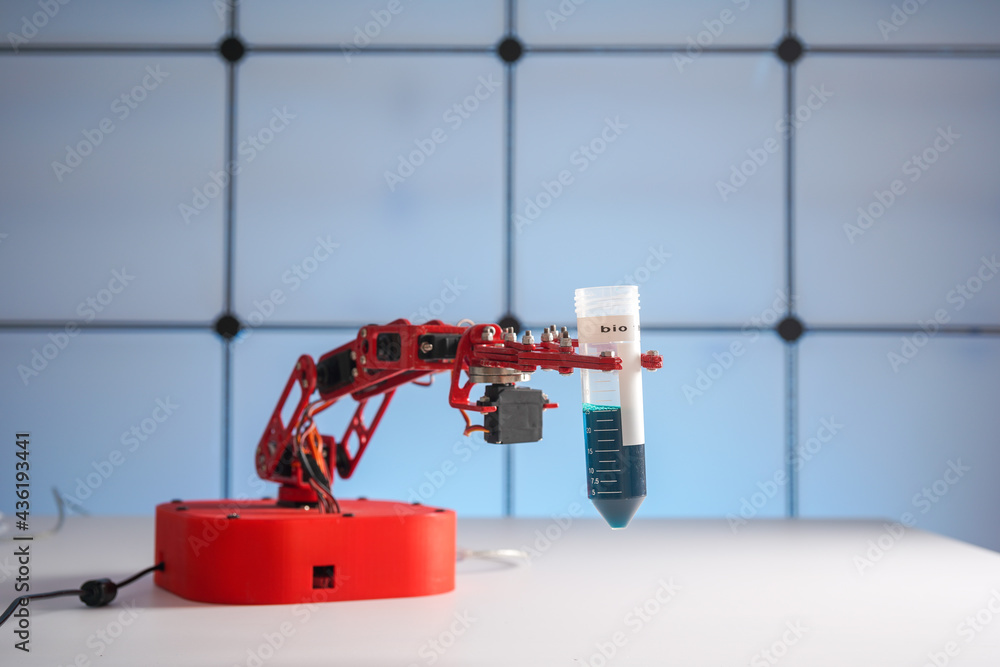 Robot arm with test tube  with biological sample in science laboratory