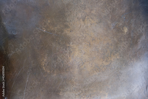The texture of the worn bronze or brass background is covered with a patina	 photo