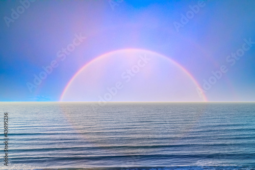 Rainbow over empty sea minimalistic photo