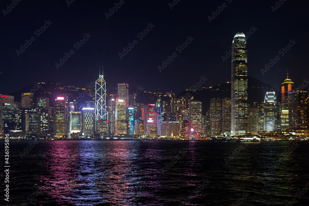 Fototapeta premium Wieżowce na wyspie Hong-Kong oświeltone bogato po zmierzchu 