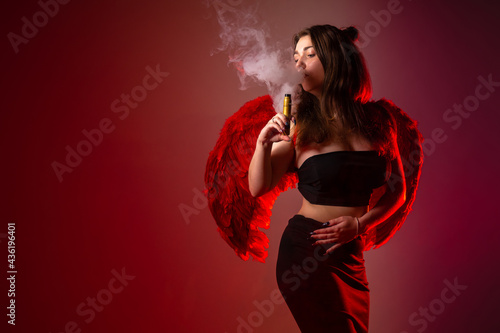 A girl smokes a VAPE on a r...
