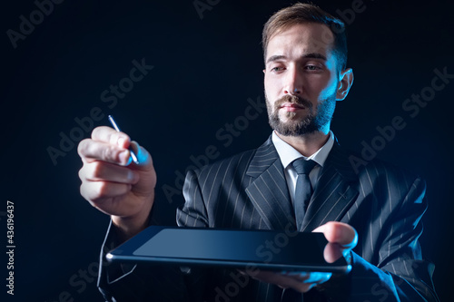 A man is holding a tablet w...