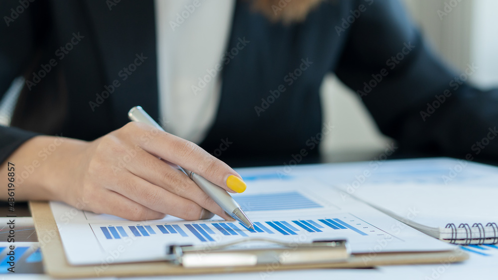Businessmen analyze financial graph charts that show results and calculate strategies for planning a company's success process. Businessmen analyze financial graph charts that show results and calculate strategies for planning a company's success process.
