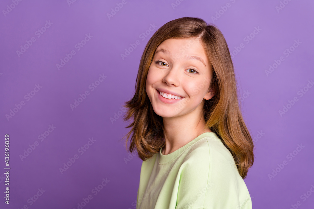 Profile side photo of young cheerful cute girl happy positive toothy smile isolated over purple color background Profile side photo of young cheerful cute girl happy positive toothy smile isolated over purple color background