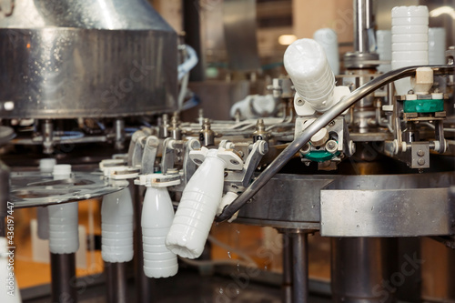 filling milk in to plastic bottles at the factory. equipment at the dairy plant