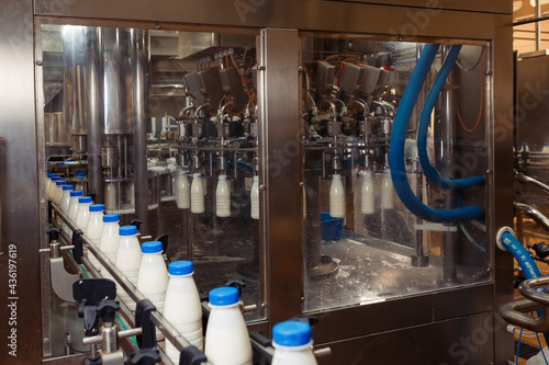 filling milk in to plastic bottles at the factory. equipment at the dairy plant