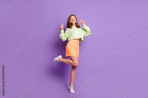 Fototapeta Naklejka Na Ścianę i Meble -  Full size profile side photo of young preteen girl happy positive smile show peace v-sign hello isolated over violet color background
