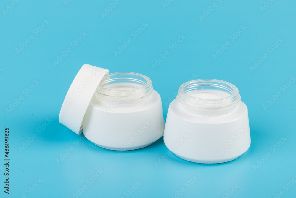 Beauty Cream Texture Close Up. Cosmetic skincare product in jar on blue background. High Quality Beauty Cream Texture Close Up. Cosmetic skincare product in jar on blue background. High Quality