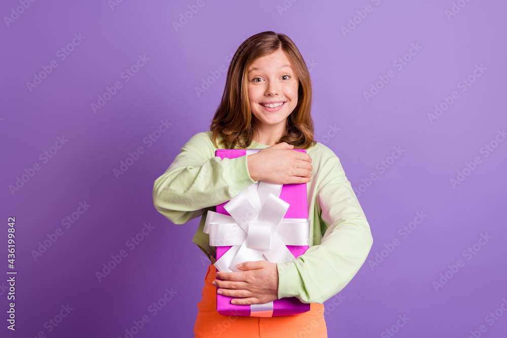Photo of young excited girl happy positive smile hug cuddle present box party isolated over violet color background Photo of young excited girl happy positive smile hug cuddle present box party isolated over violet color background