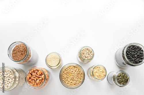 Variety of legumes and seeds in glass jars. Zero waste storage, no plastic, healthy food concept