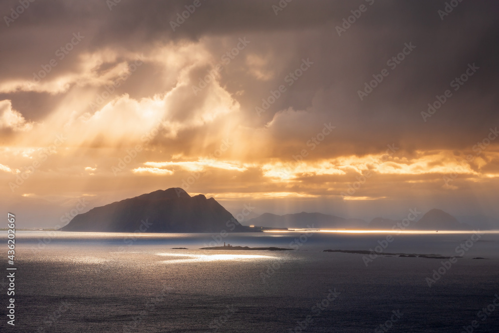 Sunbeams over an island on the sea