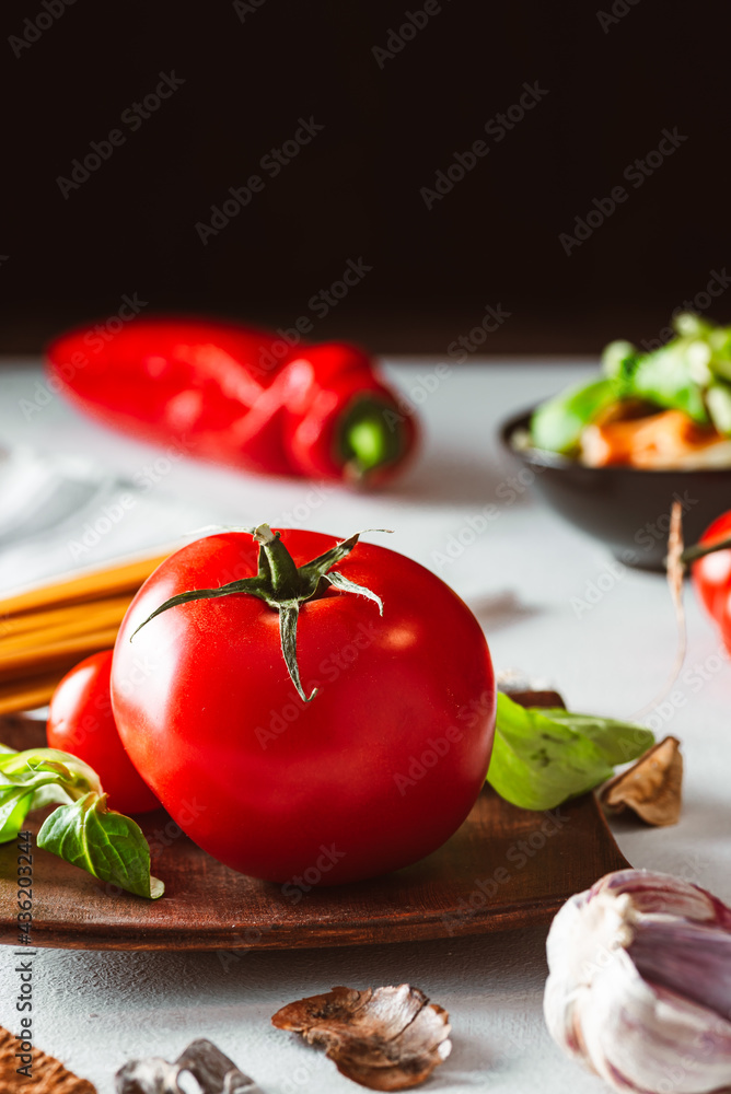 Juicy tomato with pasta and vegetables on bright background. Spaghetti base. Juicy tomato with pasta and vegetables on bright background. Spaghetti base.