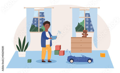 Little cute boy playing with radio controlled toy in room