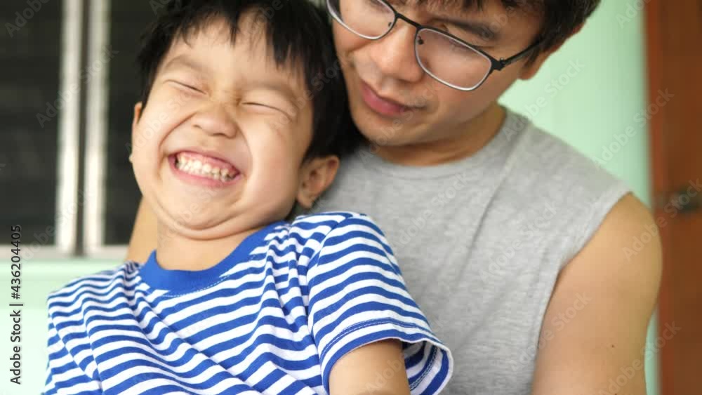 4K Authentic son laughing, smiling with happy face while looking on smartphone outdoor with father. Concept of good relationship, technology connection, father's day, social media, togetherness. 4K Authentic son laughing, smiling with happy face while looking on smartphone outdoor with father. Concept of good relationship, technology connection, father's day, social media, togetherness.
