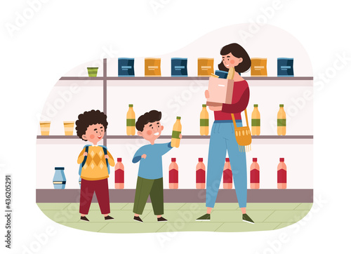 Family with two little children shopping in a grocery store together