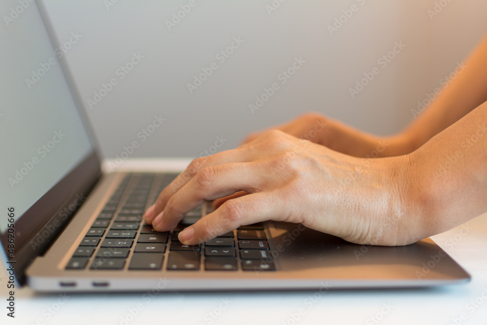 Close up of female hands working on a laptop with selective focus Close up of female hands working on a laptop with selective focus