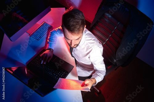 Office worker works in a da...