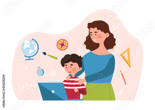 Young mother and son working together on laptop doing his classwork
